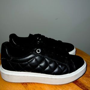 Steve Madden black faux leather platform shoes.